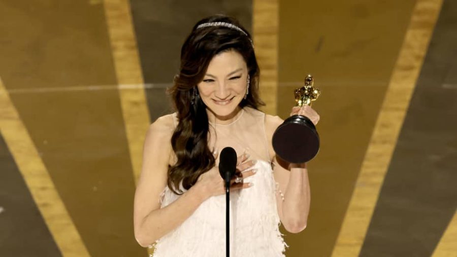 Giving her speech on stage, Michelle Yeoh accepts the Oscar for Best Actress. (Photo courtesy of CNBC)
