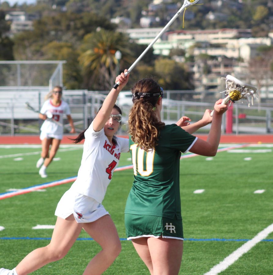 Obstructing a pass, junior Maya Mihara defends during a game against Head-Royce School. (Photo by Lauren Poulin)