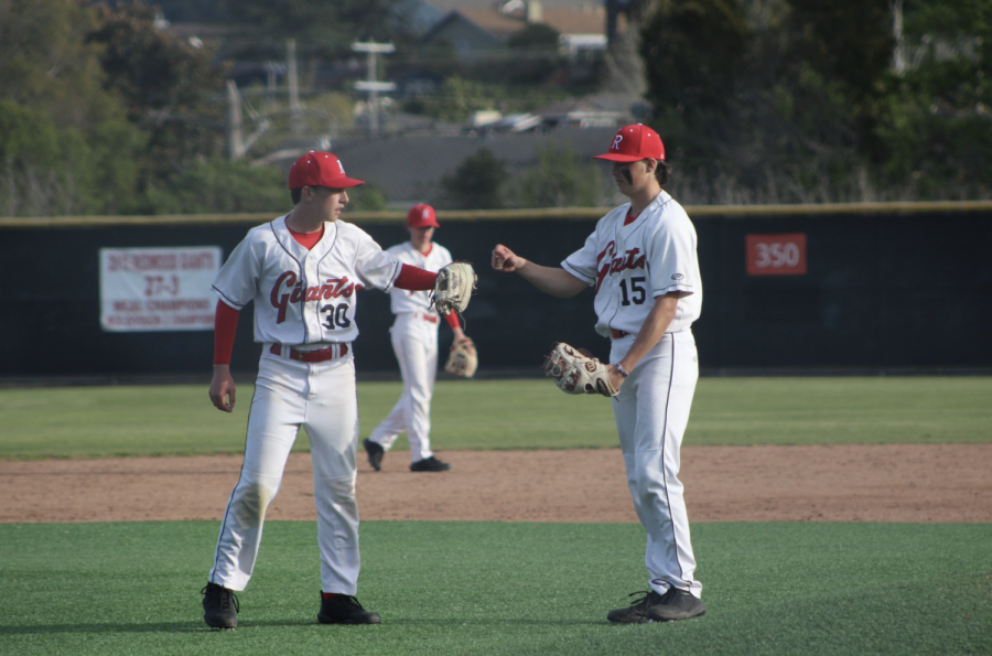 Celebrating after Veley gets a strikeout, sophomore Lucas Ghio fist bumps Veley.