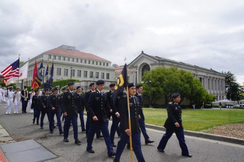Marching in formation, ROTC Cadet Armando Hisquierdo waves a flag and takes the lead of the Cal Berkeley Army ROTC Battalion. (Photo courtesy of Armando Hisquierdo)