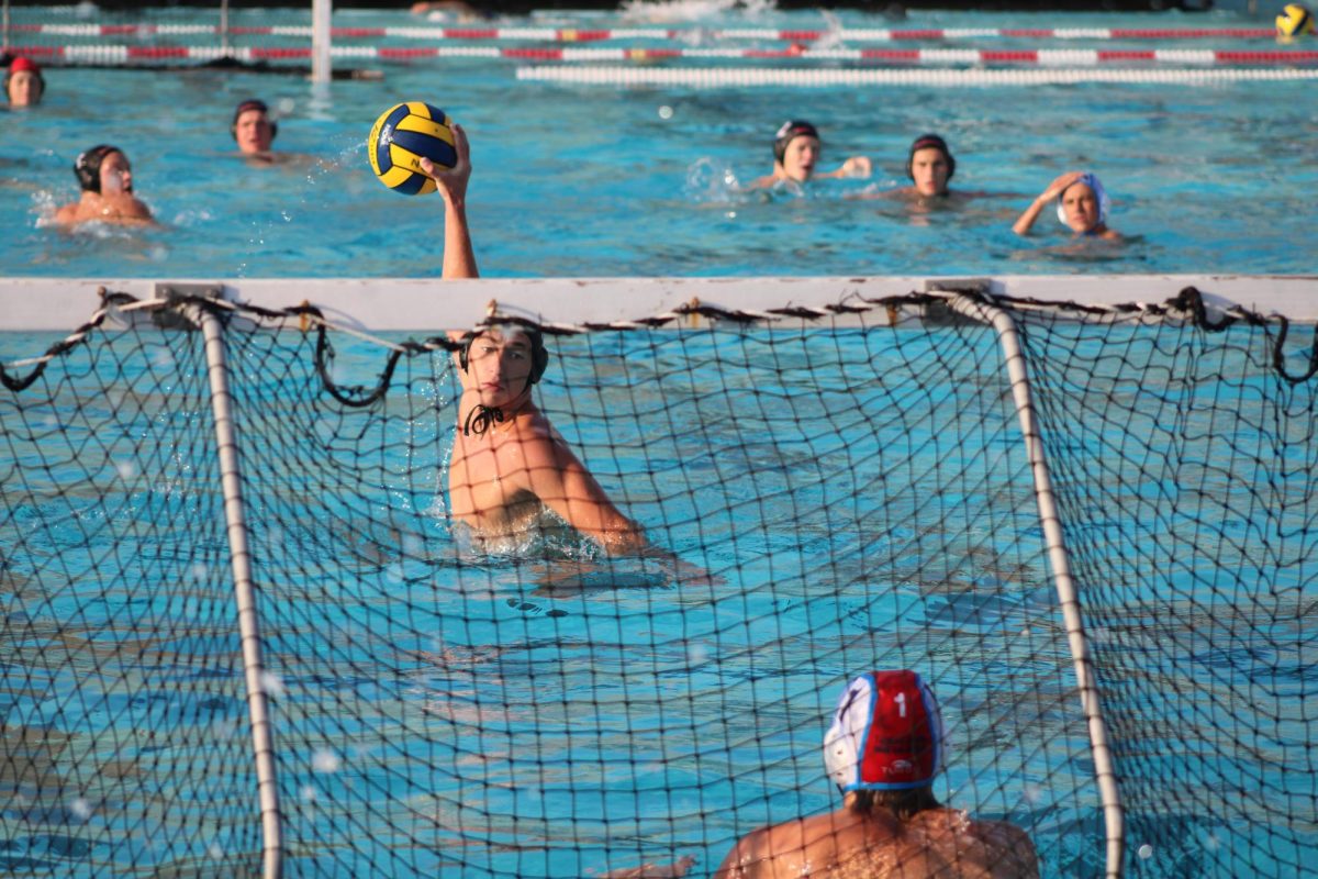 Lining up for a five meter shot, junior Sawyer Goldberg reaches back to shoot.
