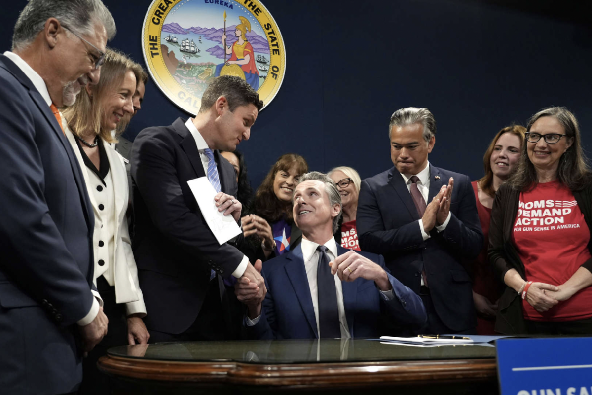 Governor Gavin Newsom shakes hands with assemblymember and author of AB 28, Jesse Gabriel (Photo courtesy of AP News).