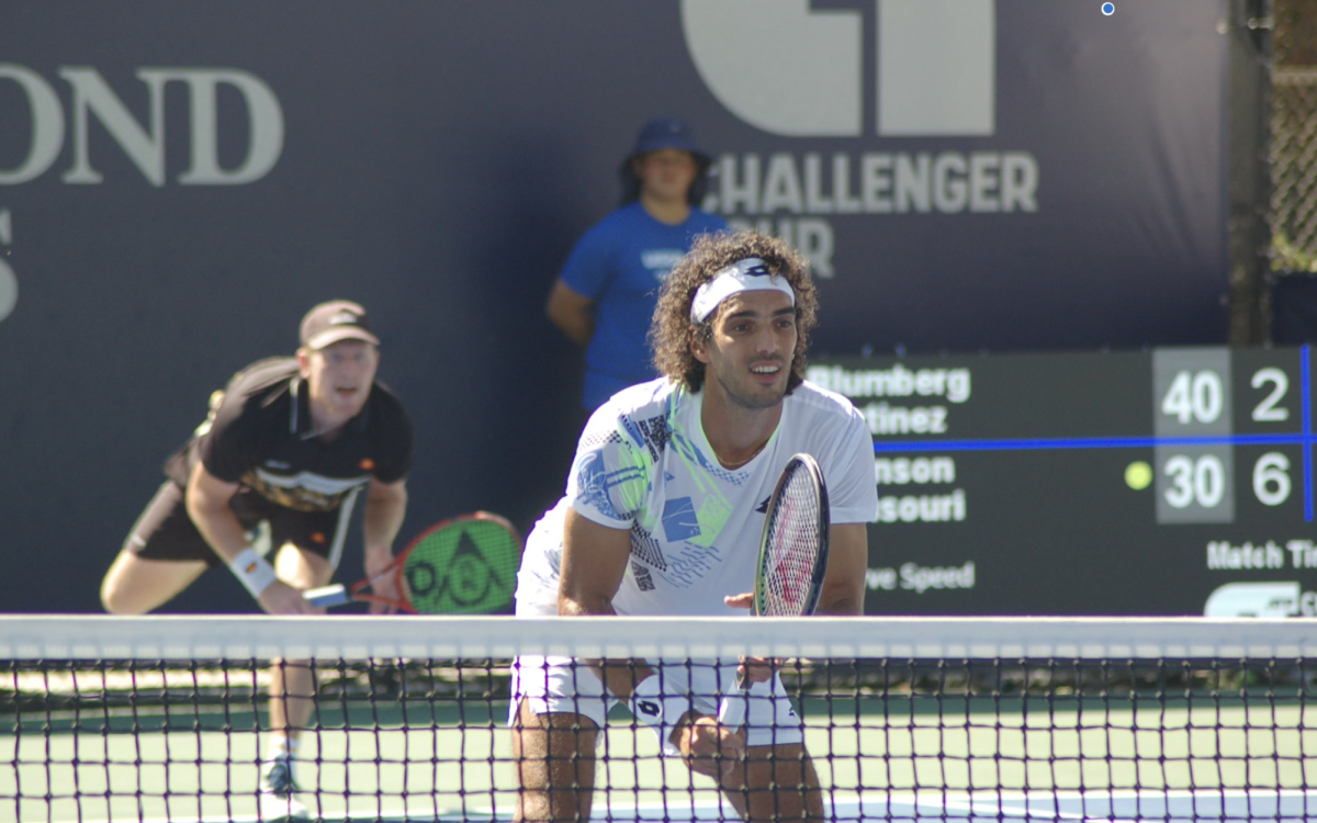 Ducking in front of the net, Skander Mansouri downsizes to not get hit by his pair’s serve.
