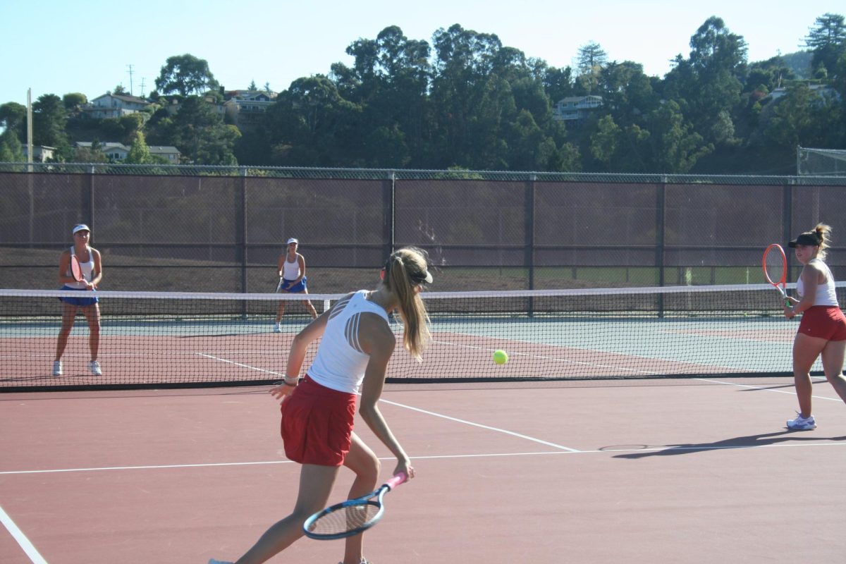 Preparing to smash a forehand, junior Gwen Ricordel readies her racket.