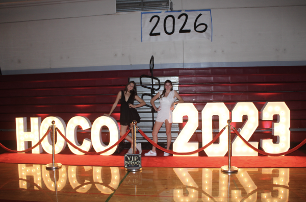 Standing with the signs, seniors Cameryn Smith and Ella Kaminski get their photos taken. 
