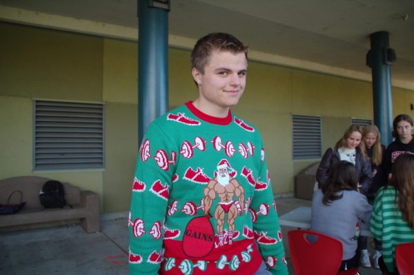 Senior Max Sherman’s holiday sweater shows off his comical spirit as he waits for his soup. 