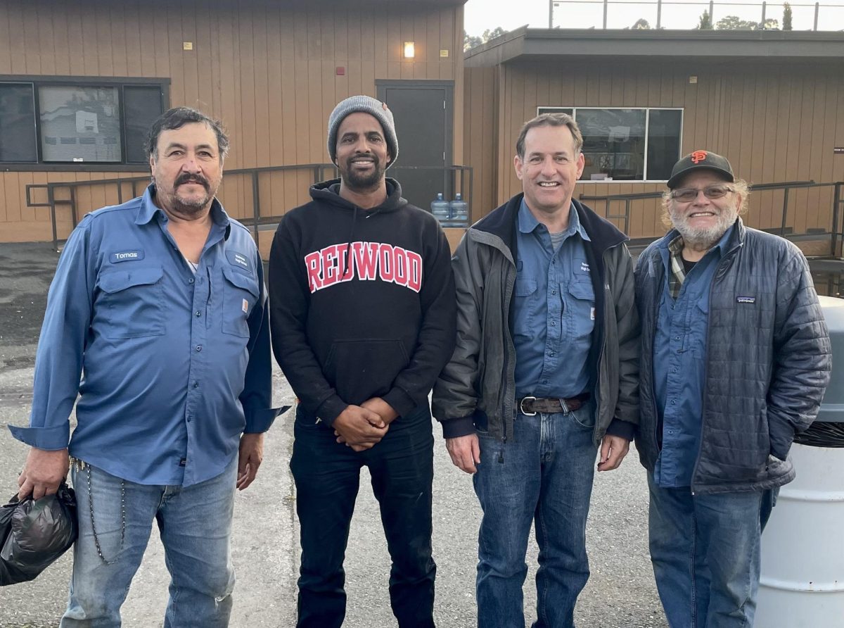 Roberto Cordoba, Paul Potter, Amanuel Gebremichael, and Tomas Herera stand before Redwood’s portable classrooms ahead of their night shifts. 
