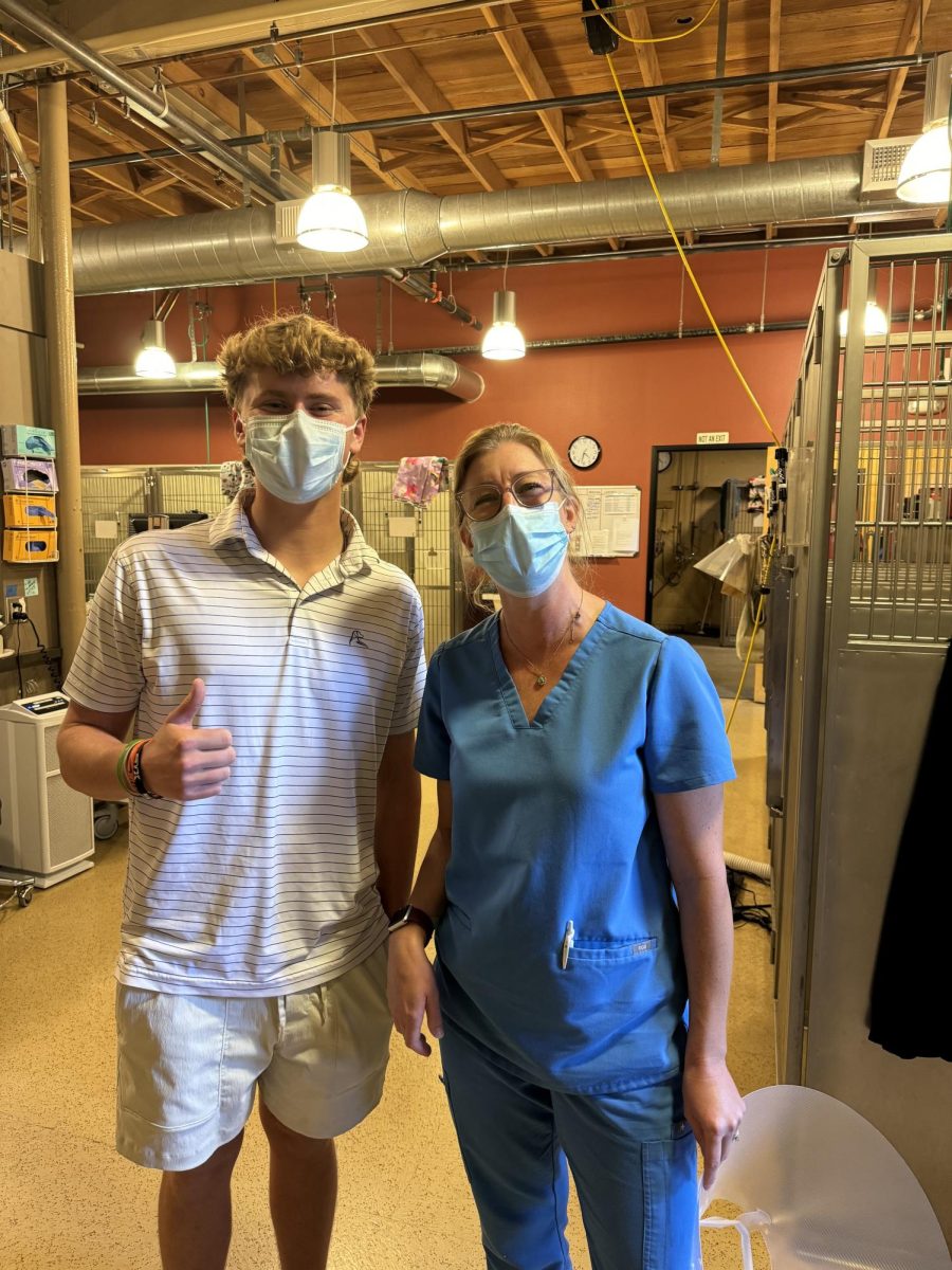 Masked up in the clinic, Lesher follows the work of veterinary technician Danielle Puccioni. (Photo courtesy of Jackson Lesher)
