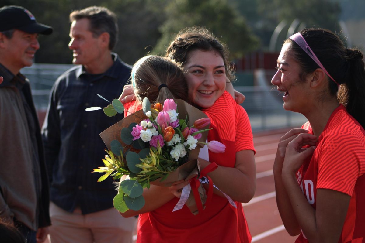 Dakota Ledesma embraces a teammate following the ceremony.