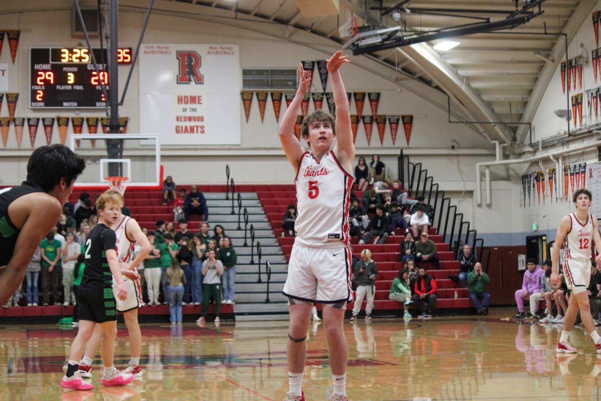 Leaving his arms in the air, Mason Garbo takes a free throw shot in the third quarter. 