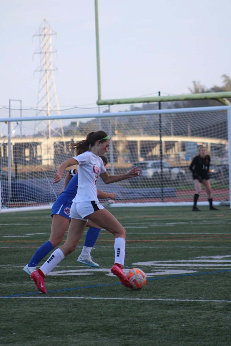Sarah Farese dribbles down the sideline towards the goal.