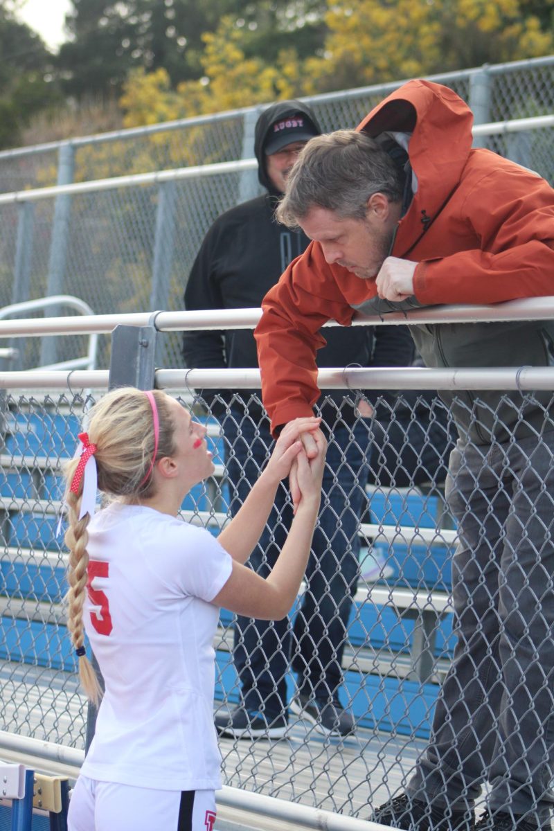 Talking with her father at halftime, senior Caroline ODonnell  prepares for the rest of the game.