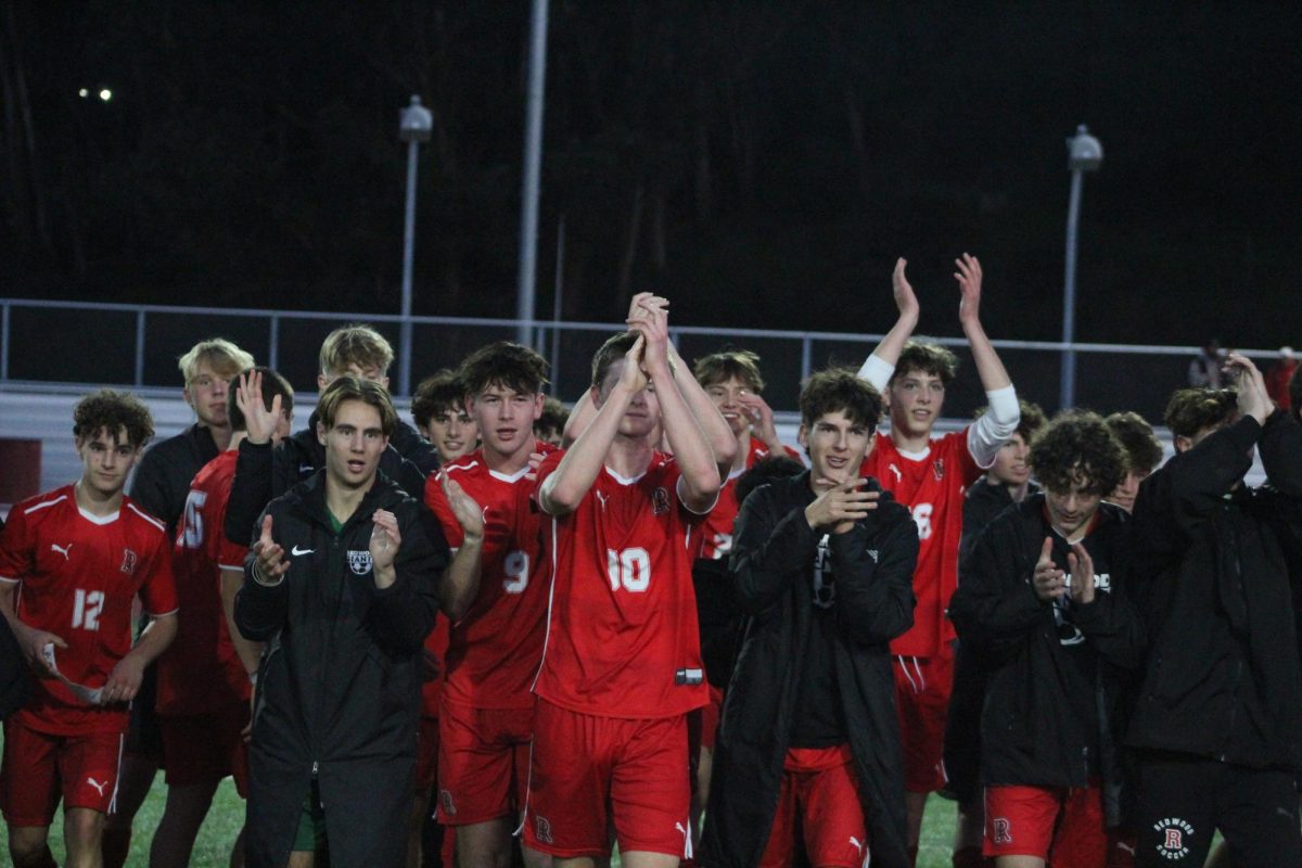 After winning the MCAL championship, varsity boys’ soccer walks off the field clapping.
