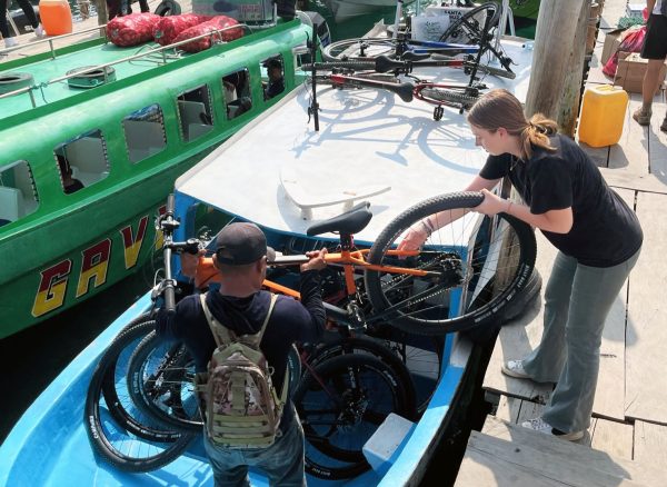  Loading the boat with 11 bikes for the students, Ginger Howard prepares to head to Santiago Atitlan. (Photo courtesy of Ginger Howard)