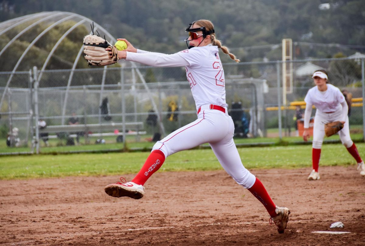 Winding up her pitch, sophomore pitcher Stella Belluomini throws a strike.