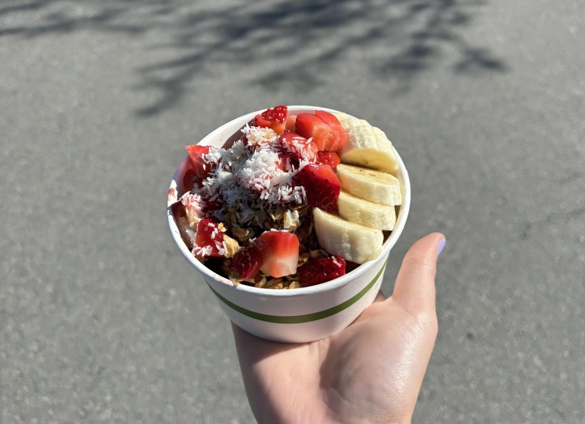 Bowl from Juice Girl, topped with sweet fruit and coconut flakes
