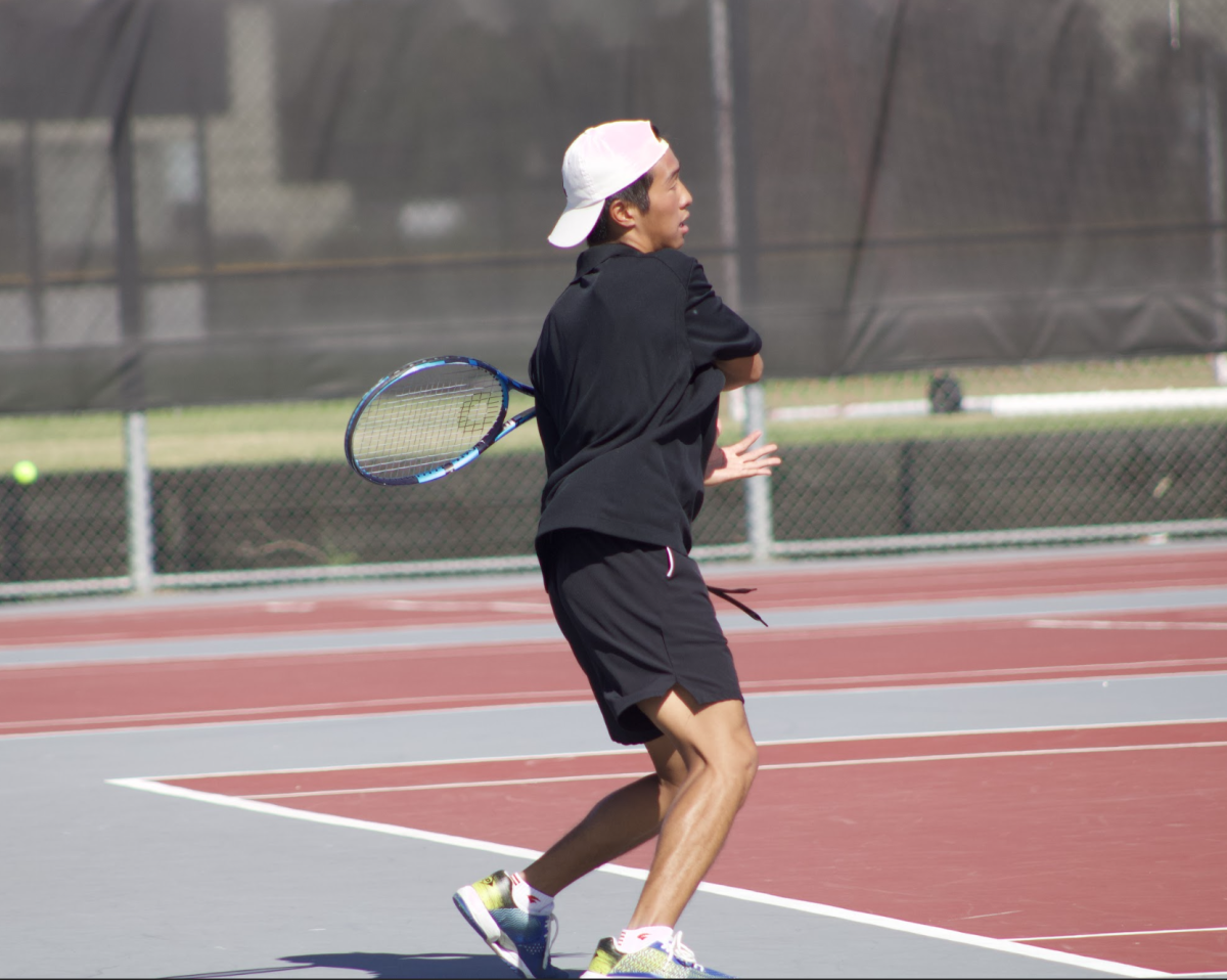 Senior captain Chris Lee hits the ball forehand to win the point.