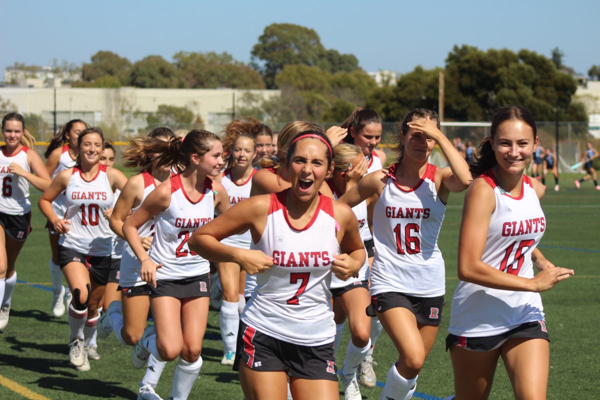 Running their warm-up lap, seniors Francesca Mitchell and Maya Saibel lead their team. 