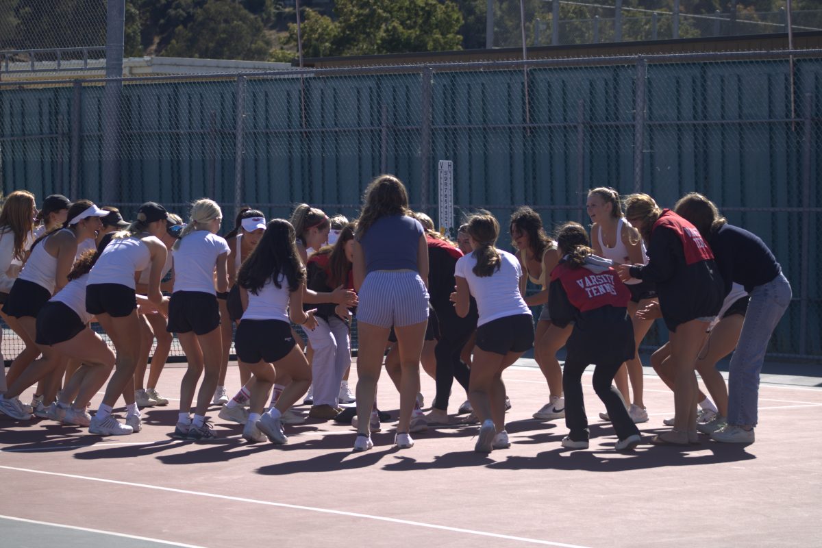 Girls’ varsity tennis completed their pre-game ritual chant to fire up for the match.