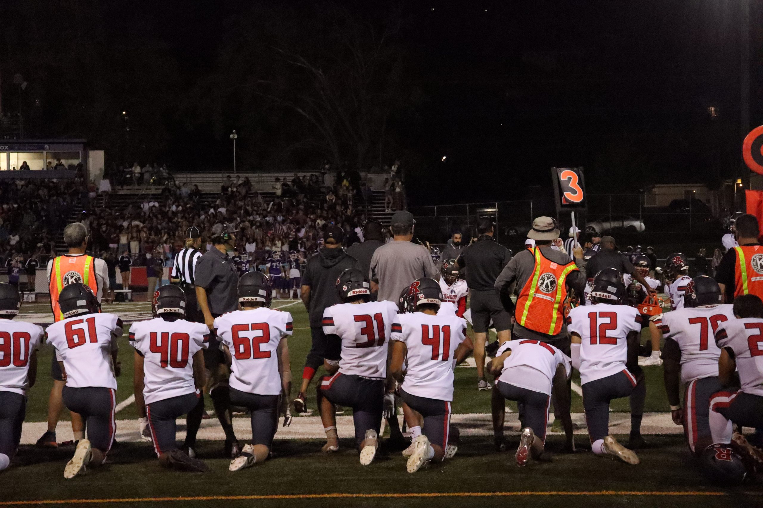 The crowd holds their breath as the Giants kneel for junior Ben Vaughn after a hard-hit tackle. 