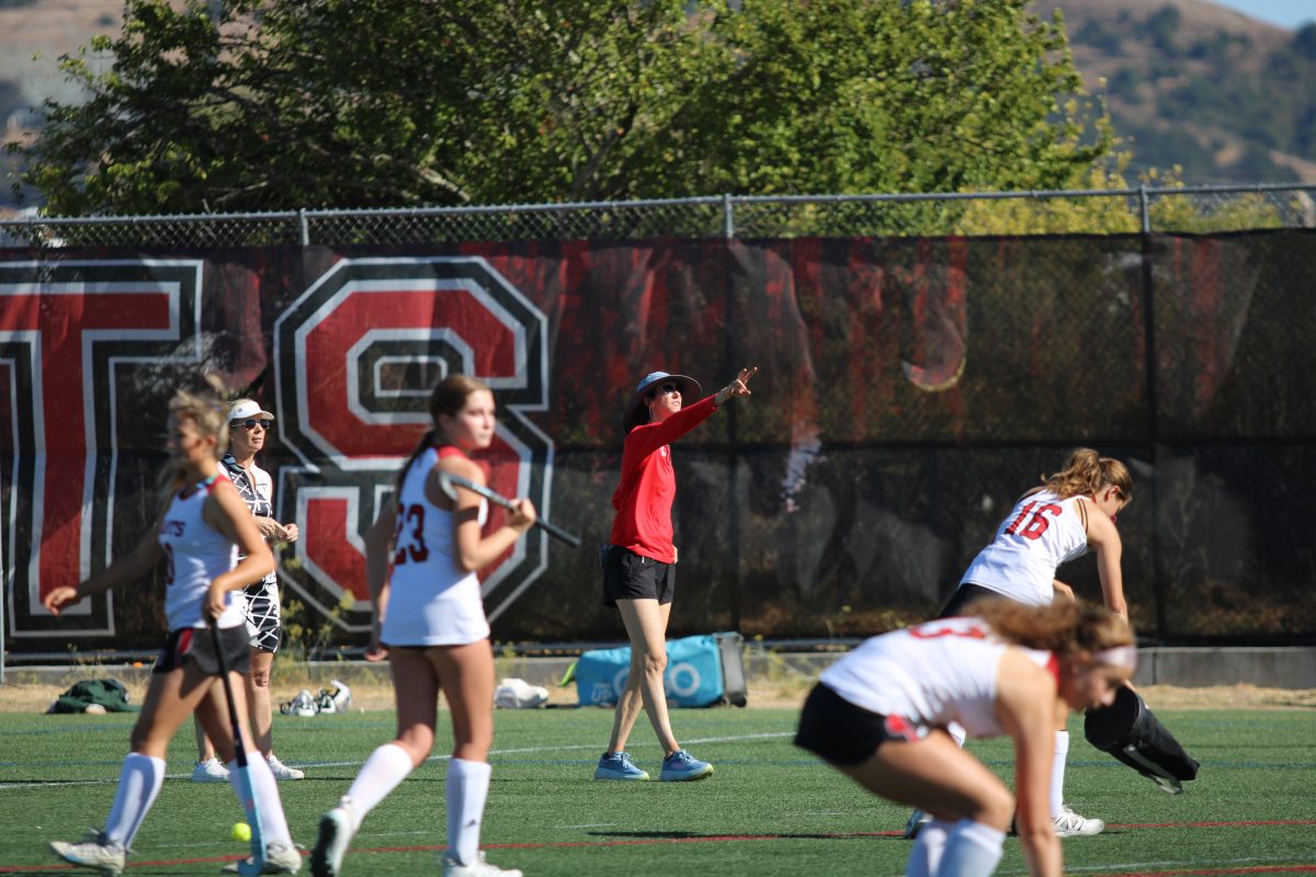 Coach Aline Copp gives instructions to her players during warmups.