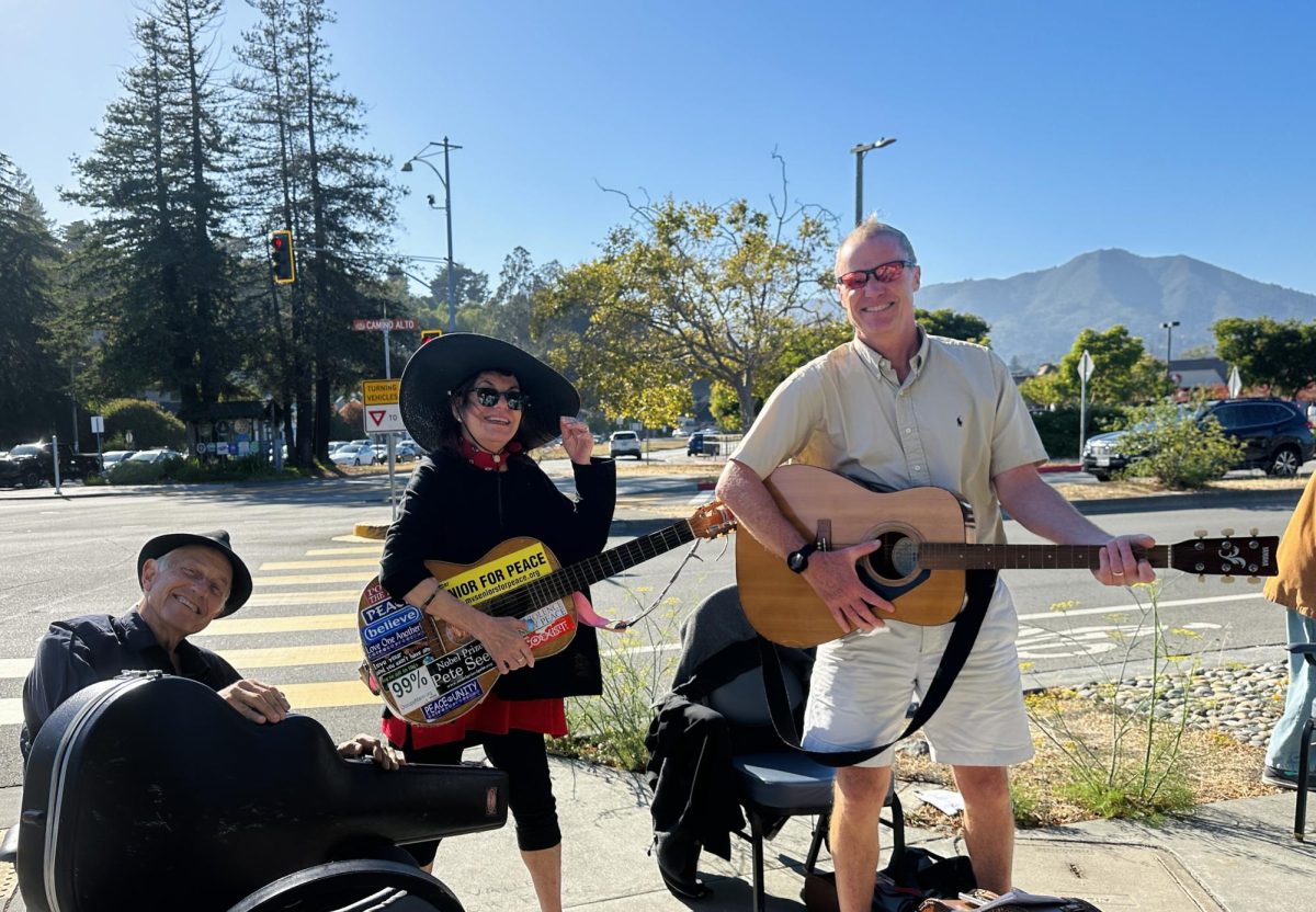 Mill Valley Mayor Urban Carmel (right) and Mill Valley Citizens for Peace members use musical instruments to enhance their protests on a sunny day.

