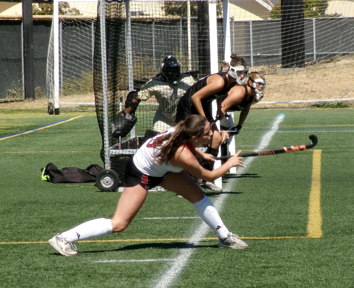 Powerfully swinging her stick, senior Lucy Tonderys inbounds the ball to her team.