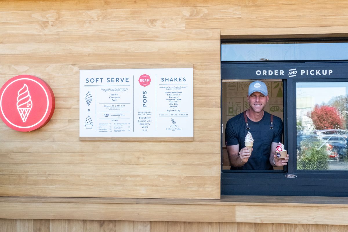 Showing off delicious soft serve, co-founder Joshua Spiegelman stands at the pick-up window.