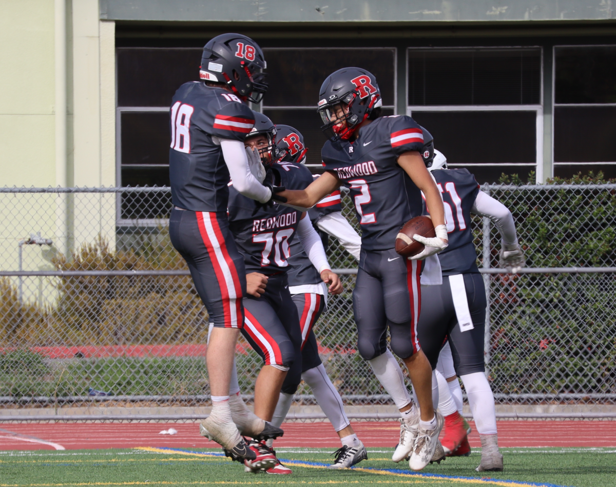 Senior Ashlin Quach (2) celebrates after a thrilling 30-yard touchdown run, putting the Giants up 7-0 in the second quarter.
