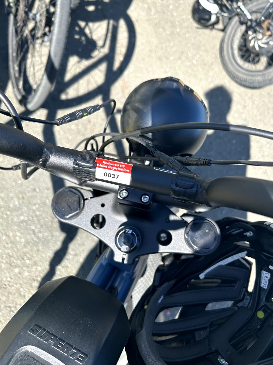 A registration tag on an e-bike displays the e-bike registration number