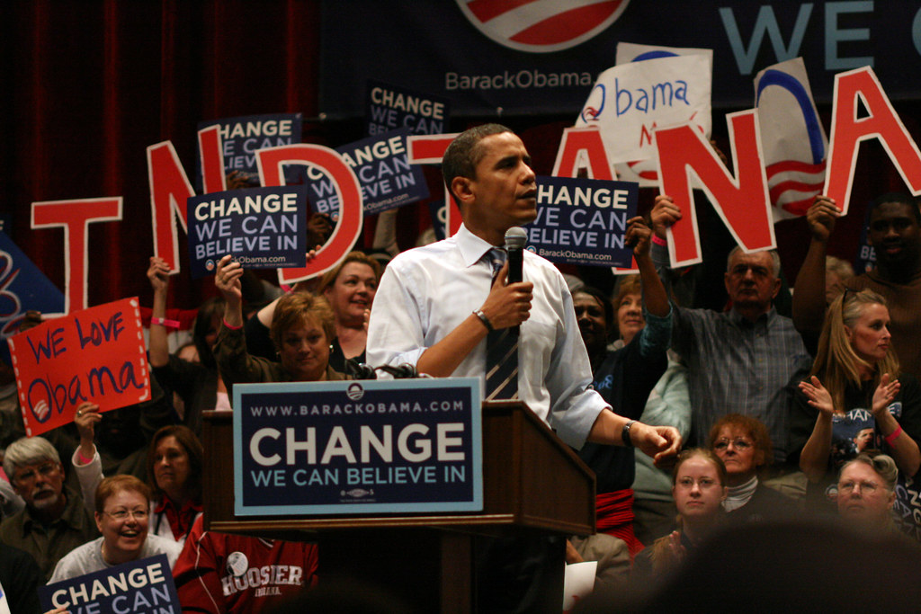 Former President Barack Obama on his 2008 campaign trail with his slogan, "Change We Can Believe In" on posters from supporters. (Photo courtesy of Flickr.com)