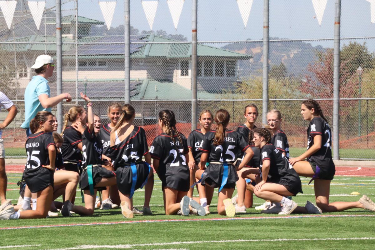 The senior girls take a knee to support teammate Charlotte Lacy after an ankle injury.
