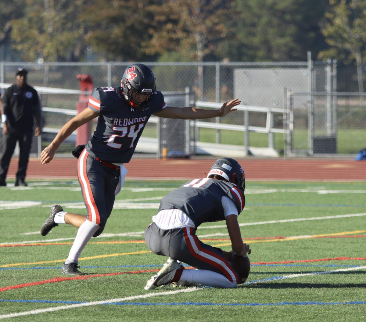 Lining up the football, junior kicker William Suko nails an extra point attempt. 
