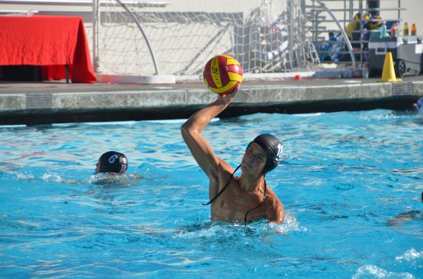 Freshman Alex Marron raises the ball above his head for his practice shot. 