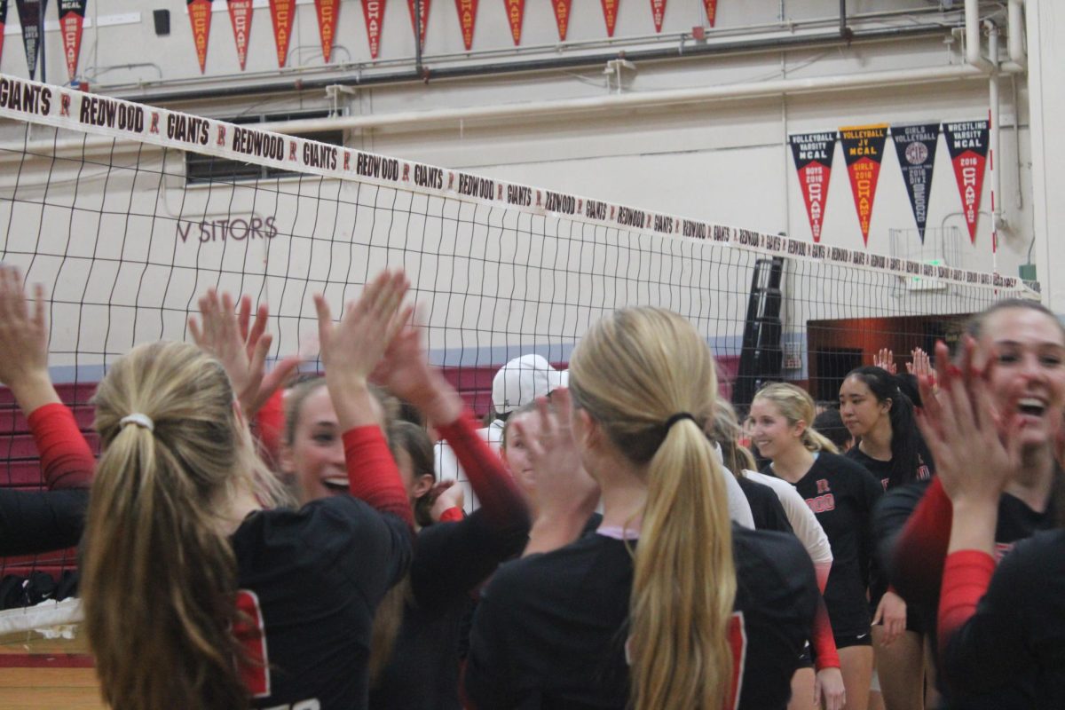 Redwood Giants celebrate their 3-0 victory with high fives all around.
