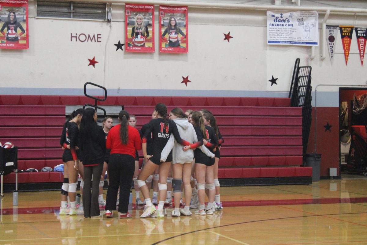 Head coach Jane Seslar delivers focused instructions for the team, preparing them for the third set.
