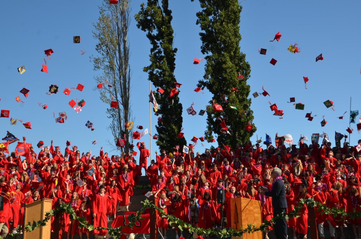 Seniors launch their caps in the air as Dr. Barnaby Payne announces they have officially graduated. 