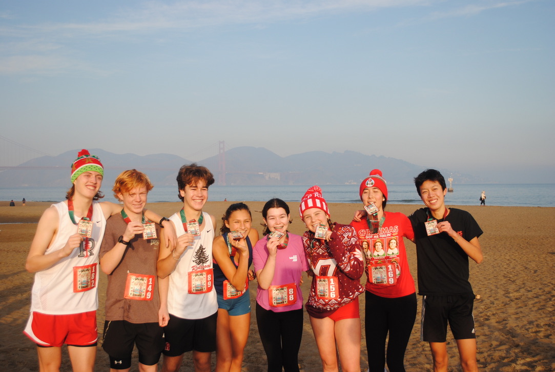 McCaw, Neimi, Roth, sophomore Josephine Perlov, freshman Daisy Roth, juniors Lucy Howard and Saki Beattie and Xu pose with their medals on the beach.