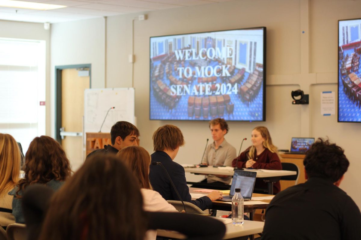 Sixth-period Government students converse with their party members, awaiting the commencement of the mock senate. Some jot down last-minute notes, while others highlight key talking points.
