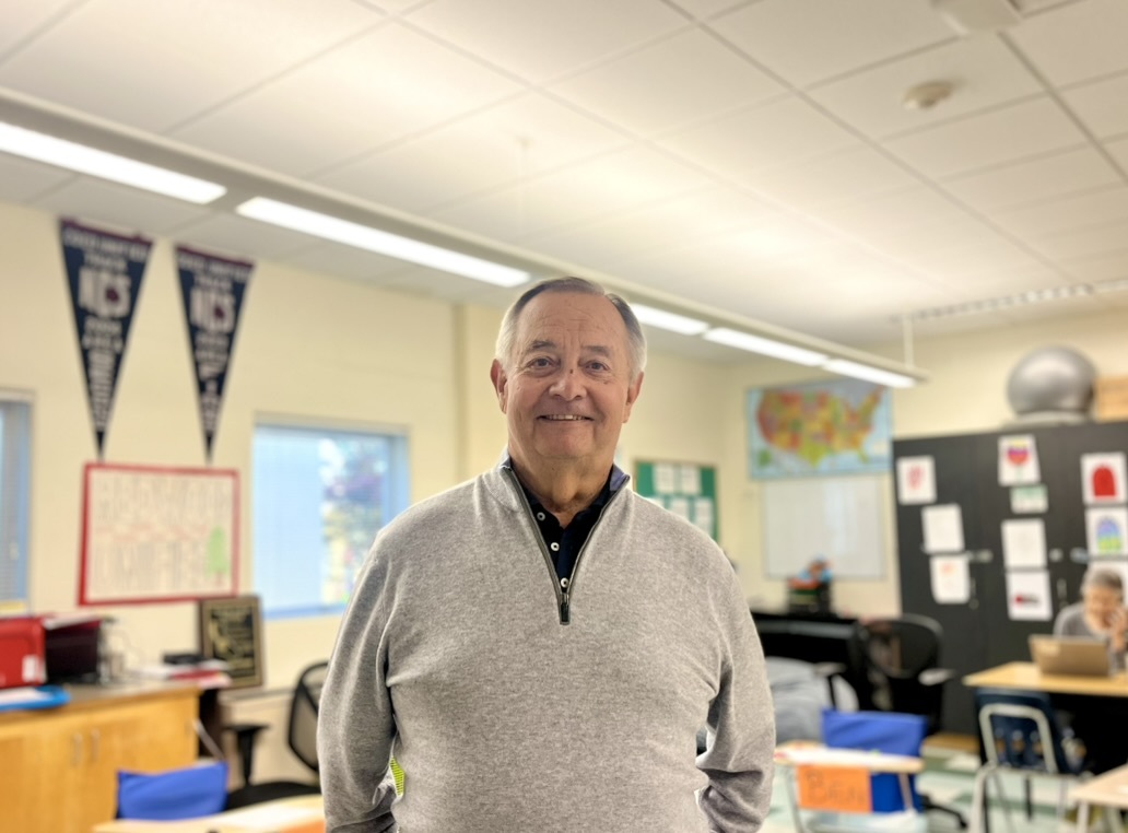 Jack Goodman, a two-year support teacher, stands in his classroom. He is committed to building connections and encouraging inclusivity among all students.
