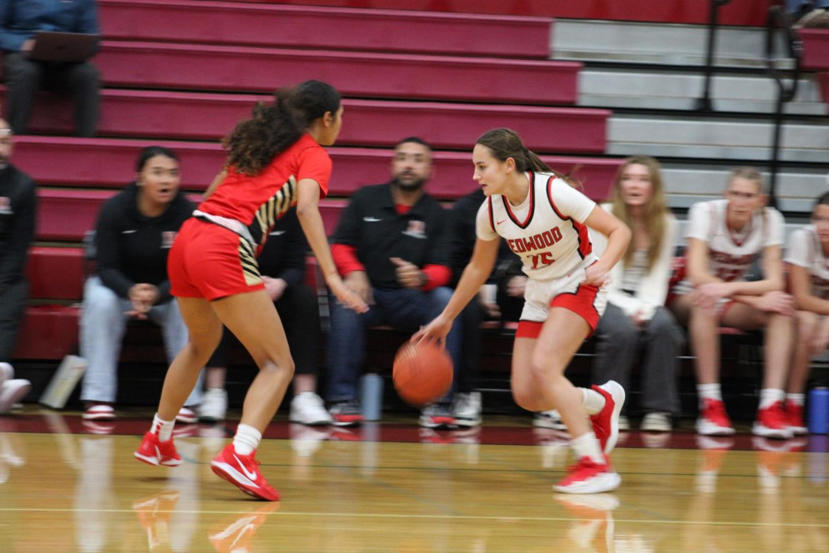 Keeping her eye on the defender, Saibel dribbles the ball towards the net.