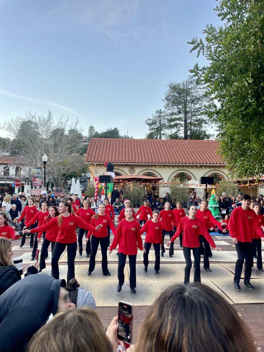 Teens from Happy Feet Dance School group performed a multitude of holiday tap performances, drawing in a large crowd with their energetic performance and synced choreography.