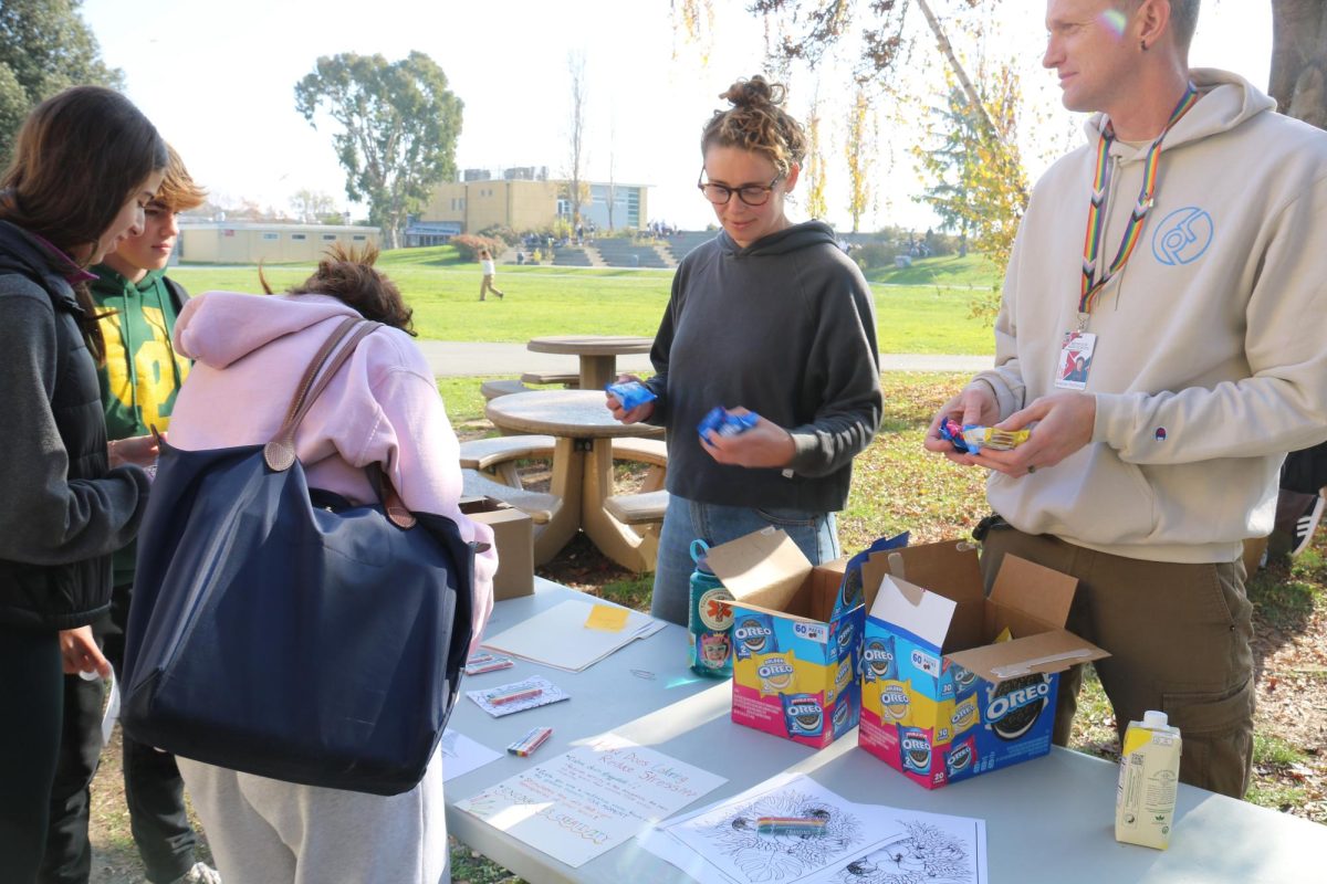 Wellness Coordinator Spencer DeWoody hands out Oreos to students during Wednesday’s Stress-Less event. 
