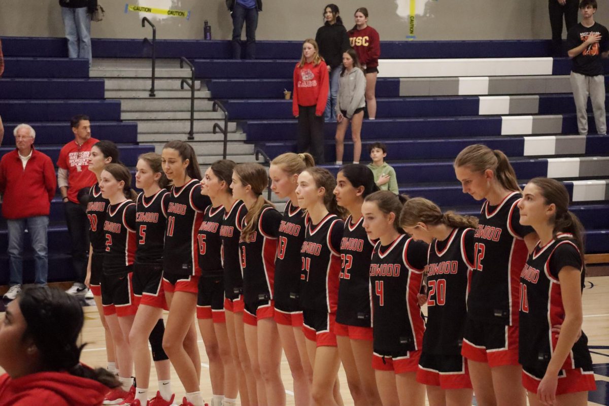 Girls’ varsity basketball lines up for the national anthem before their 58-52 victory over Marin Catholic. 
