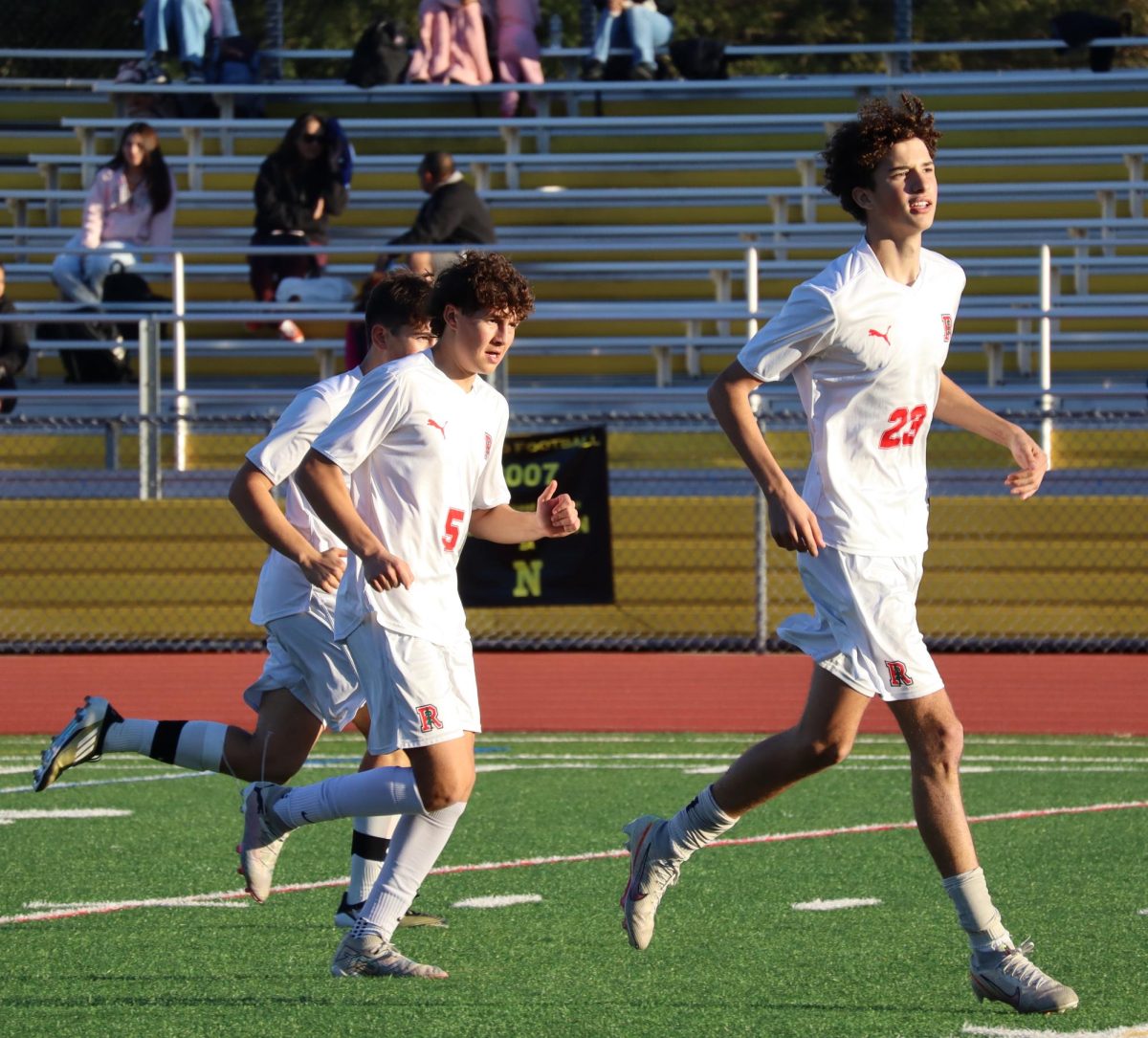 After scoring the game's last goal,  sophomore Van Bowers (23) runs to his teammates.