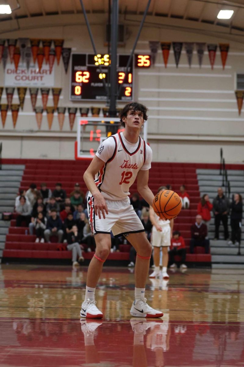 Holding the ball in his left hand, sophomore Harrington White prepares for a free throw. 