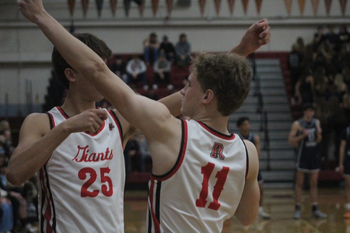 Senior Duke Aarsheim and Kody Vasquez complete the bow and arrow to end their handshake. 