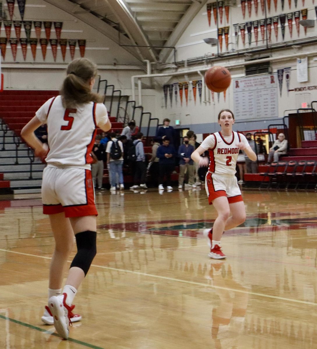 Senior captain Molly Gallagher (5) relays the ball to her twin, fellow captain and point guard Ainsley Gallagher (2).