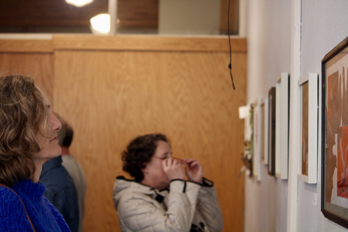 Parent Sharra Weasler appreciates student art as she peruses the gallery.