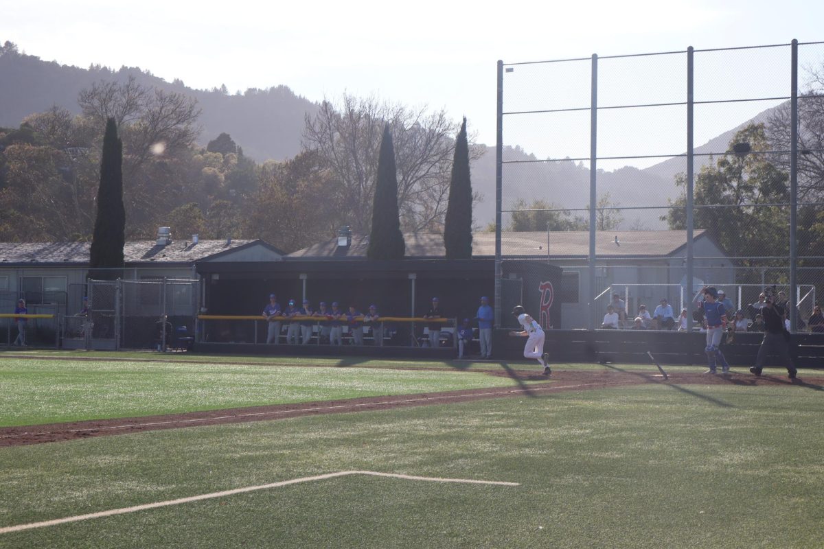 Senior Kaelin Christman runs to first base after hitting the ball.

